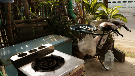 Old Vintage Gas Stove and Kitchen Tools in the Sunの写真素材
