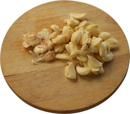Smashed Garlic on Wood Chopping Board - Isolatedの写真素材