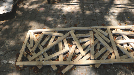 Small Pieces of Rustic Woods in Long Wooden Frame on Dirty Pavement Texture with Paint -  Abandoned Garden/ Garage/ Backyard/ Outdoor Junkyardの写真素材