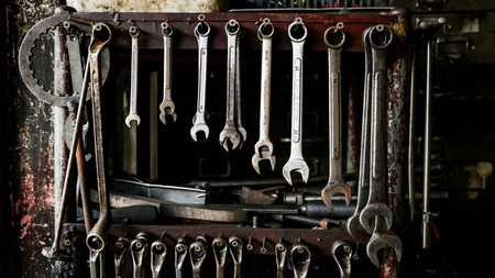 Set of Dirty Wrenches/ Spanners on Wooden Shelf with Different Tools in Garage. Motorbike Repair Shop in  Thailand.の写真素材