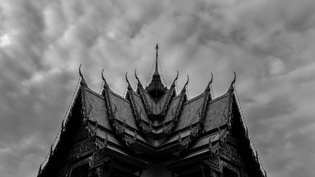 Monochromatic Symmetrical Buddhist Temple Roof in Bangkok Thailand with Beautiful Patterns. Cloudy Skyの写真素材