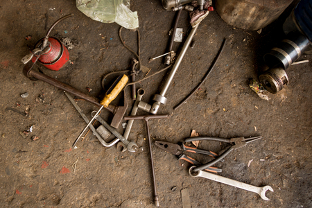 Greasy Tools on Dirty Concrete Floor. Messy Garageの写真素材