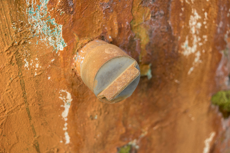 Dirty Old PVC Valve/ Plastic Water Pipeline - Vintage Moldy Wall Texture. Abandoned Garden. Yellow Warm Toneの写真素材
