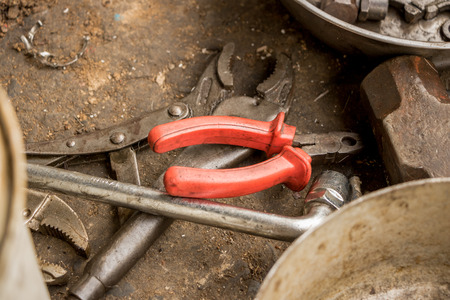 Greasy Tools on Dirty Concrete Floor. Messy Garageの写真素材