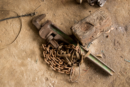 Greasy Tools on Dirty Concrete Floor. Messy Garageの写真素材