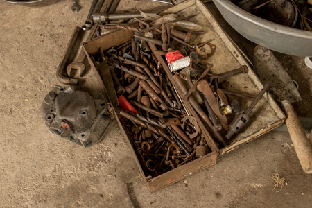Greasy Tools on Dirty Concrete Floor. Messy Garageの写真素材