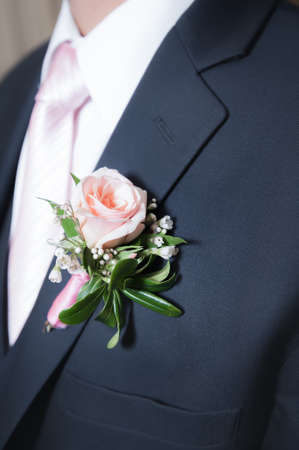 The groom wears a touch of the bride`s chosen color of pink by wearing a coordinating tie, shirt and...