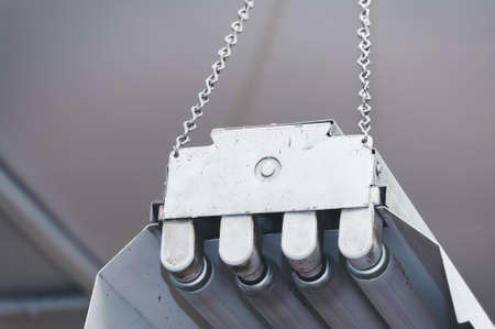 An old fluorescent light hanging from the ceiling.の写真素材