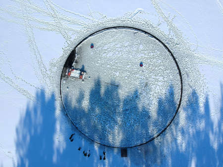 A large hole was cut out on a frozen lake. They made a big roundabout out of it, attaching the motor...