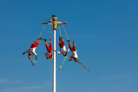Teotihuacan, Mexico - 25 of november 2019: Four men in national costumes perform the ritual dance of Volador, Mexico.のeditorial素材