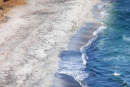 Blue waves on dirty sand, sea foam, copy paste, peruの写真素材