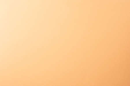 Light orange, peach color paper background, copy space.