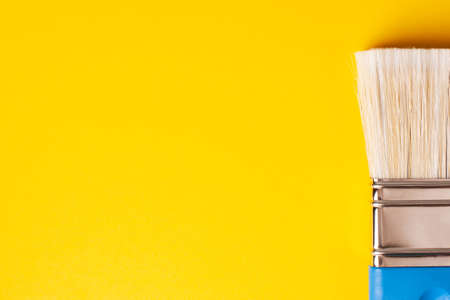 Brush close-up on a yellow background, copy paste.の写真素材