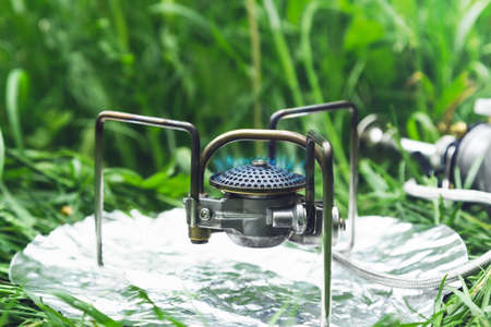 Multi-fuel burner flame on grass.