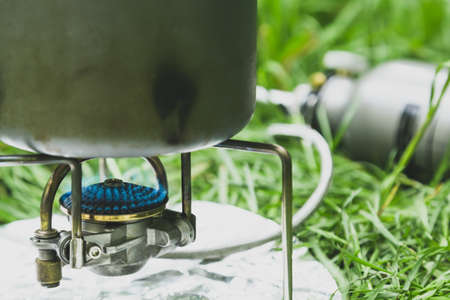 Cooking in a pot food on a tourist gas burnerの写真素材