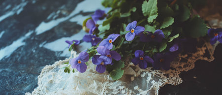Purple violets arranged with vintage lace create a delicate flat lay settingの写真素材