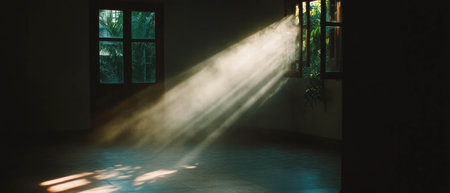 Sun rays illuminating a dusty room create a serene atmosphere filled with nostalgiaの素材