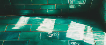 Green subway tiles with beveled edges create a timeless and elegant interior design featureの写真素材