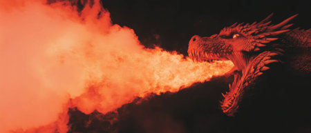 Fiery breath of a dragon illuminates the dark background in a breathtaking display of powerの素材