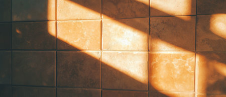 Warm beige rectangular tiles with textured surfaces in sunlightの素材