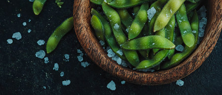 Edamame sprinkled with sea salt in a rustic bowl for a healthy Japanese snack optionの写真素材