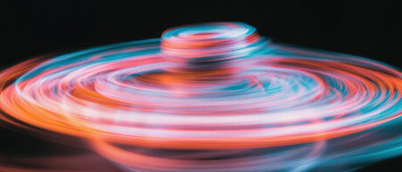 Spinning top creates vibrant motion blur with circular patterns in dynamic displayの素材