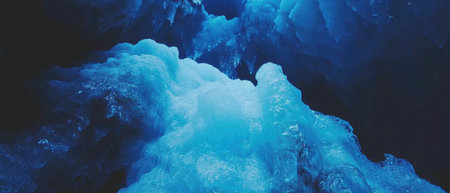 Deep blue ice glacial crevasses revealing natures stunning and perilous beautyの素材