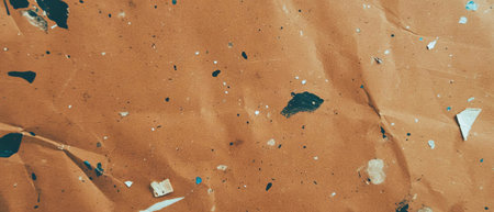 Textured kraft paper showcasing recycled fibers and unique brown shadesの素材