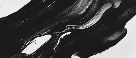 Exploring the textures of black ink with water washes on a white backgroundの素材