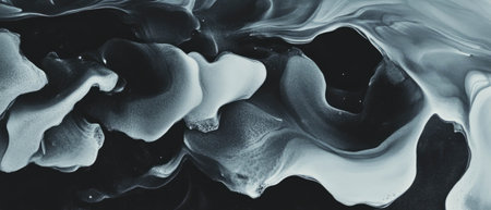 Black ink blooms create intricate textures on a stark white backgroundの素材