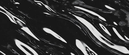 Mysterious swirls of thick black oil create an abstract atmosphere with dynamic wavesの素材
