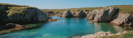 Calm turquoise water in a picturesque cove surrounded by rugged rocksの素材