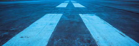 Close-up view of textured asphalt runway showing aggregate detailsの素材