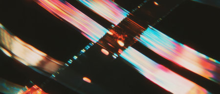 Artistic retro film texture overlay with dynamic colors on black backgroundの素材