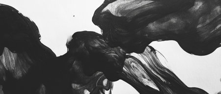 Dynamic texture of black ink in water creating fluid patterns on a white backgroundの素材