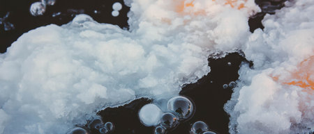 Frozen bubbles trapped in ice showcase winters unique beauty in clear formationsの素材