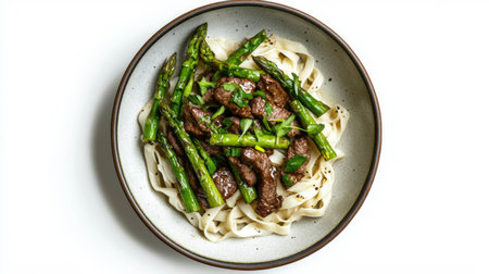 Delicious asparagus and beef stir fry on noodles for a tasty dinner experienceの素材