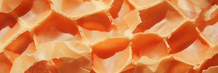 Light brown cone wafer with unique grid texture and crumbly details on displayの素材