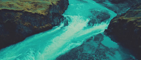 Cinematic pattern texture of a tranquil river flowing through a lush valley from aboveの写真素材