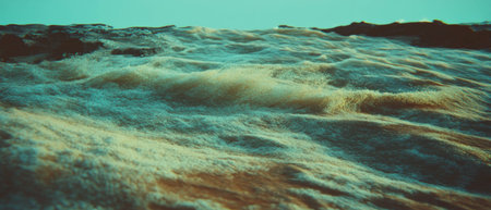 Cinematic view of soft rolling sand dunes under a tranquil sky during sunset hours