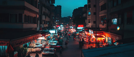 Vibrant urban street bustling with activity at night from a cinematic top view perspectiveの写真素材