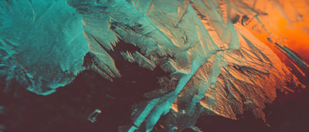 Delicate frost patterns create a cinematic texture on a windowpane at dawn