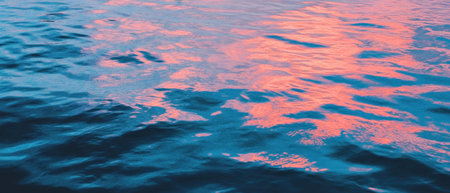 Calm river reflecting soft hues during twilight hoursの素材