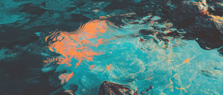 Vibrant sea landscape captured from a low angle with reflections of orange and blue huesの素材