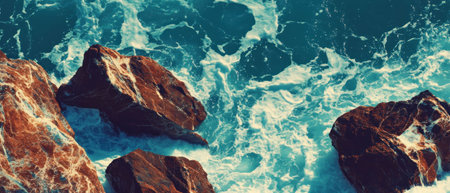 Cinematic texture of rocky coastline with crashing waves from a top view perspective