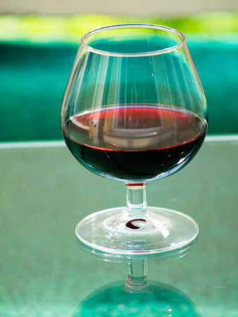 Glass with an alcoholic drink on a tableの写真素材