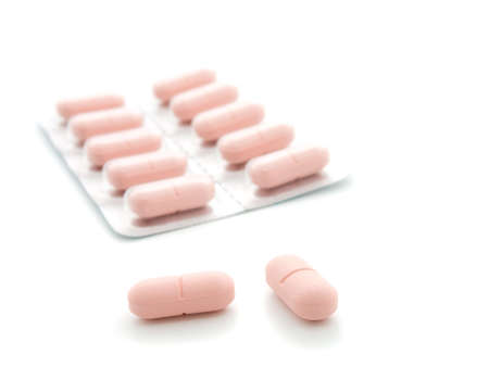 Pink tablets on a white background