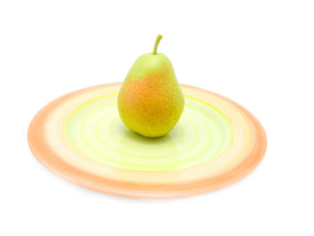 green pear on a plate over whiteの写真素材