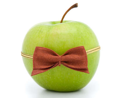 green apple with bow-tie isolated on white background の写真素材