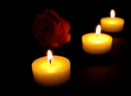 candles flaming in the dark の写真素材